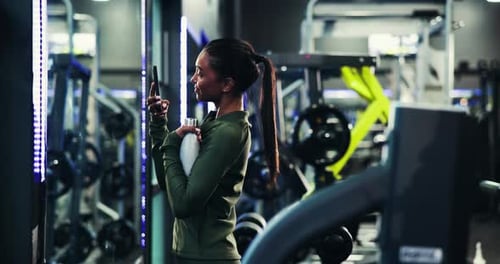 Mirror, fitness and woman in gym, smartphone and content creation with social media