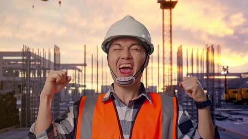 Close Up Of Asian Male Engineer Screaming Goal Celebrating Working at Construction Site