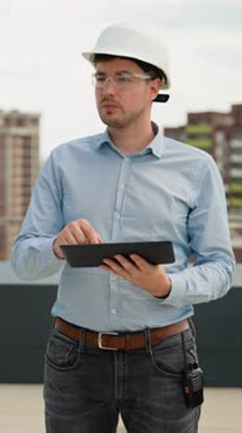 Builder Engineer Working with Digital Tablet on Construction Site