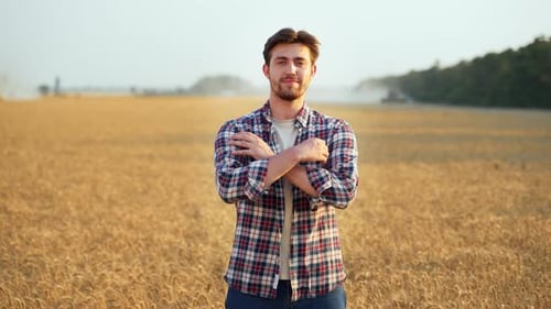 Portrait of Happy Farmer Standing in Ripe Wheat Field with Arms Crossing on Chest Proud Agronomist