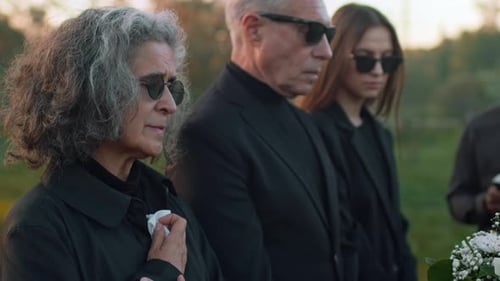 Mourners Gather at Outdoor Funeral Service