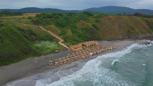 Drone flying forward to closed bar on the beach