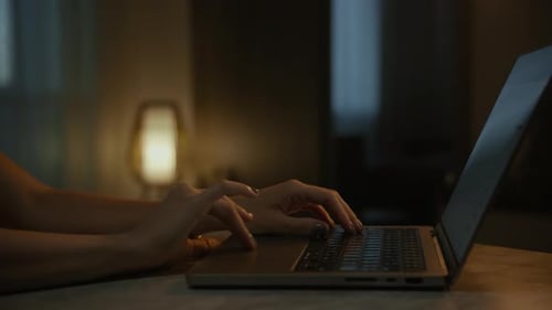 Hands Using Laptop at Night Close Up