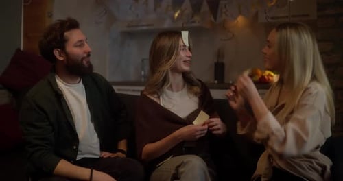 Friends Playing Card Game at Home Birthday Party