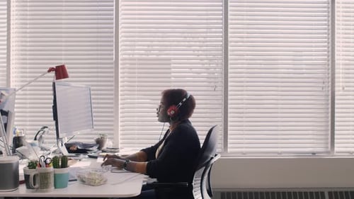 Woman Working at Computer in Bright Office