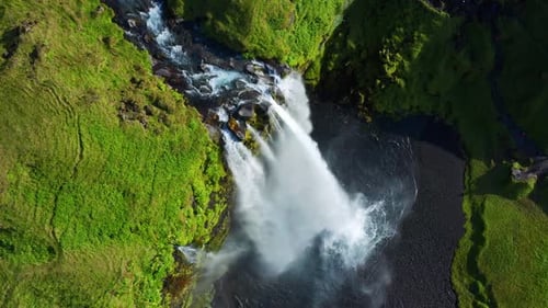 Top View Of Famous Seljalandsfoss Waterfall In Iceland With Powerful Cascade Splashing From Rocky Cl