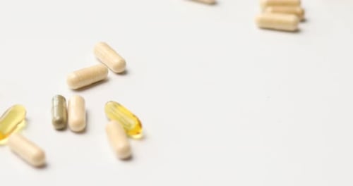 Pills and Capsules on White Surface
