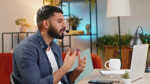 Indian Man Working on Laptop Wearing Headset Freelance Worker Call Center Support Service Operator
