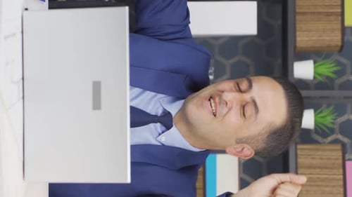 Excited Business Man Celebrating Good News at Desk