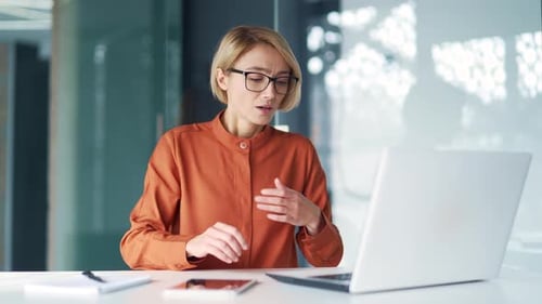 Woman Coughing at her Desk at Work