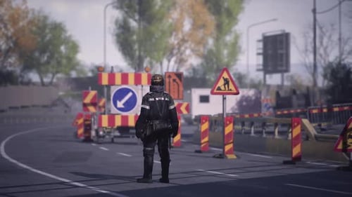Worker Directs Traffic at Road Construction Site in Urban Environment