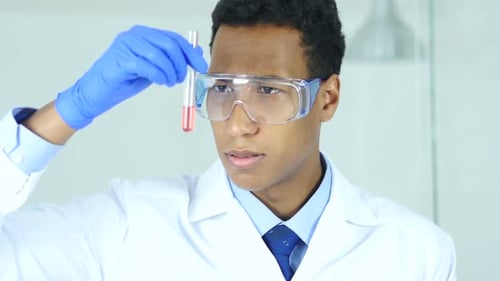 Scientist Analyzing Red Liquid in Test Tube