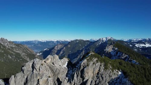 Aerial shot flying arount the mountain Alpspitz in Liechtenstein with a stunning view on other mount