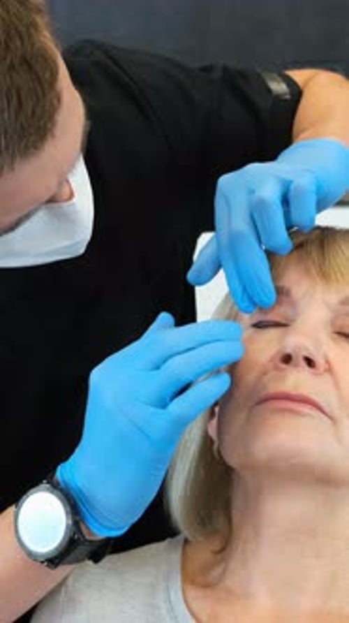 Medical Professional Examining Senior Patient's Eye
