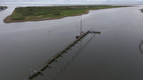 Aerial view of tranquil harbour with sailing boats and pier, Netherlands.