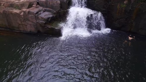 Man swimming in lake in front of waterfall. Wonderful aerial view flight
thailand jungle Waterfall