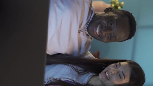 Smiling Couple Using Laptop Indoors