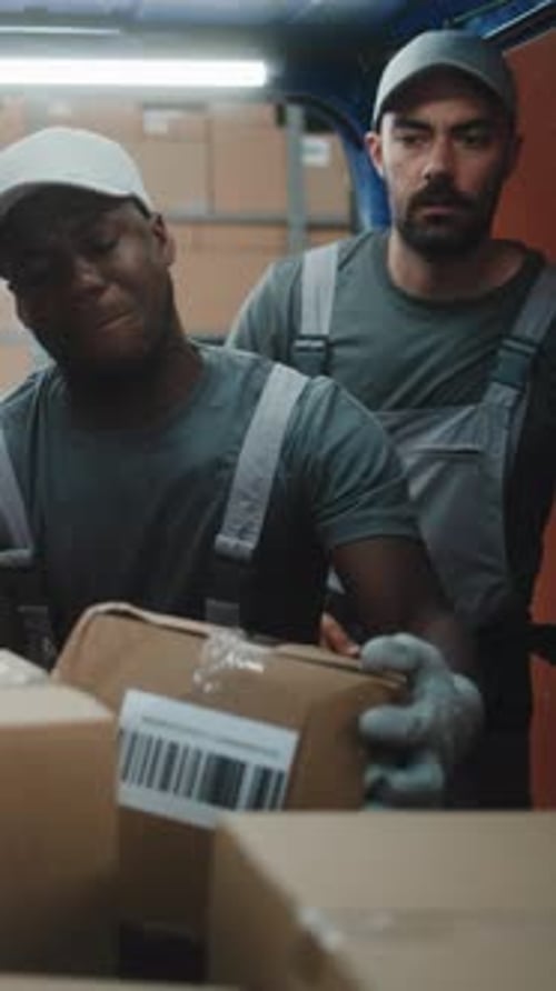 Multiethnic Workers Scanning Cardboard Boxes with Online Orders in Delivery Truck