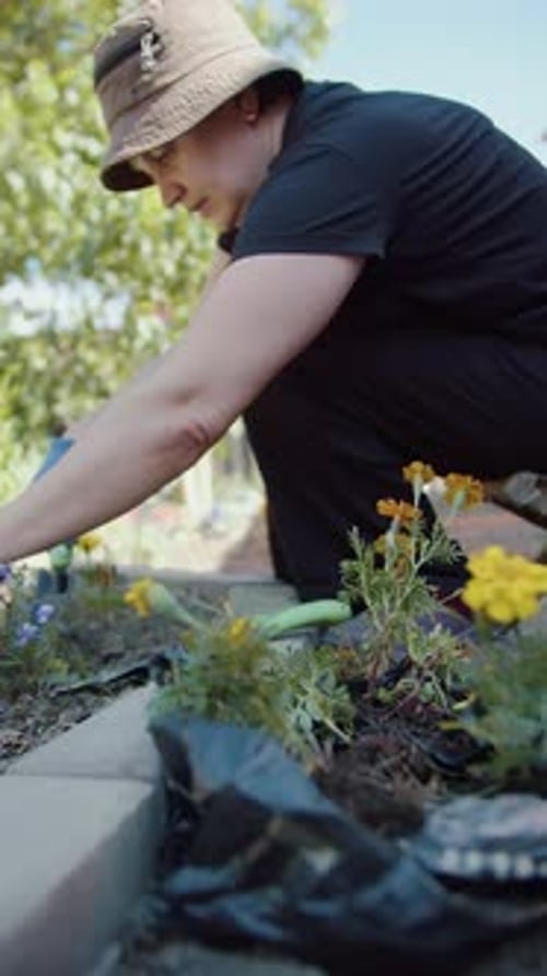Woman Gardening With Flowers at Home