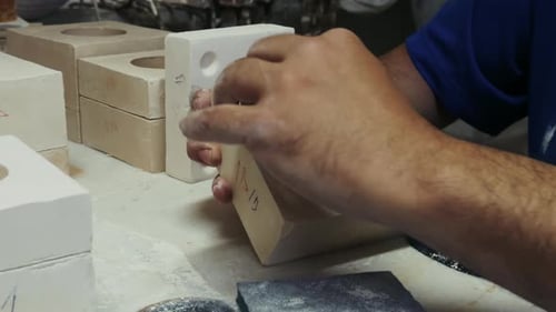 Working On A Pold Shape In Ceramic Studio Workshop