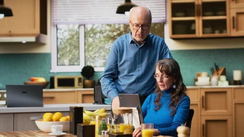 Senior Couple Using a Tablet in the Kitchen