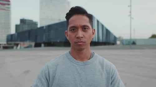 Young man crossing his arms and looking at the camera