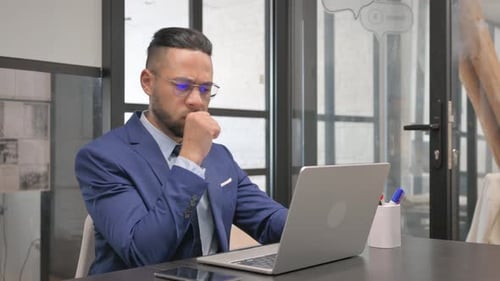 Man Working on Laptop in Modern Office Setting