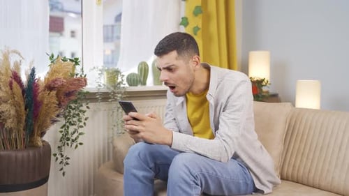 Young Man Reacts Strongly to Content on Smartphone