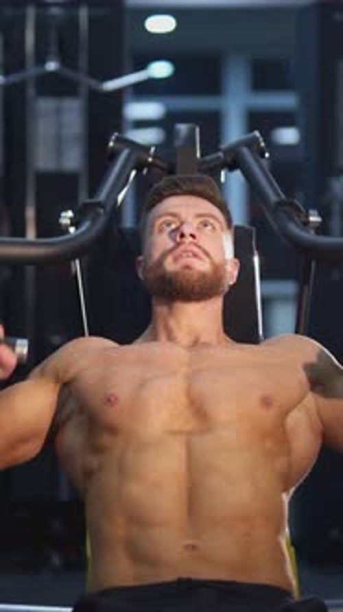 Shirtless Man Lifting Weights in Gym