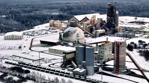 Large industrial complex covered with snow during winter, aerial view