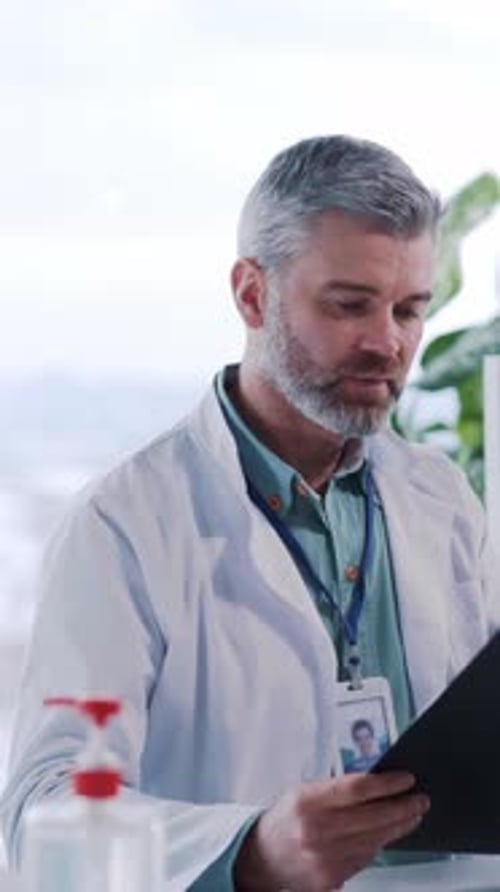 Doctor Discussing on Camera with Clipboard