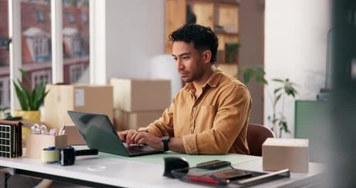 Laptop, logistics and typing with man in office for delivery, distribution or shipping management