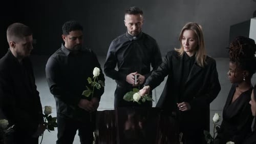 Mourners Placing White Roses on a Coffin