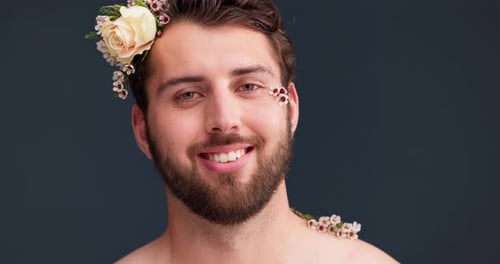 Flowers, self confidence and beauty with face of man in studio for acceptance, natural and pride