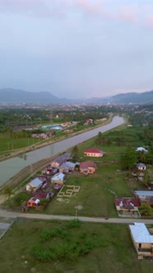 Aerial View of Village Along a Canal