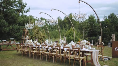 Wedding Reception Table Set Up Outdoors with Chandeliers