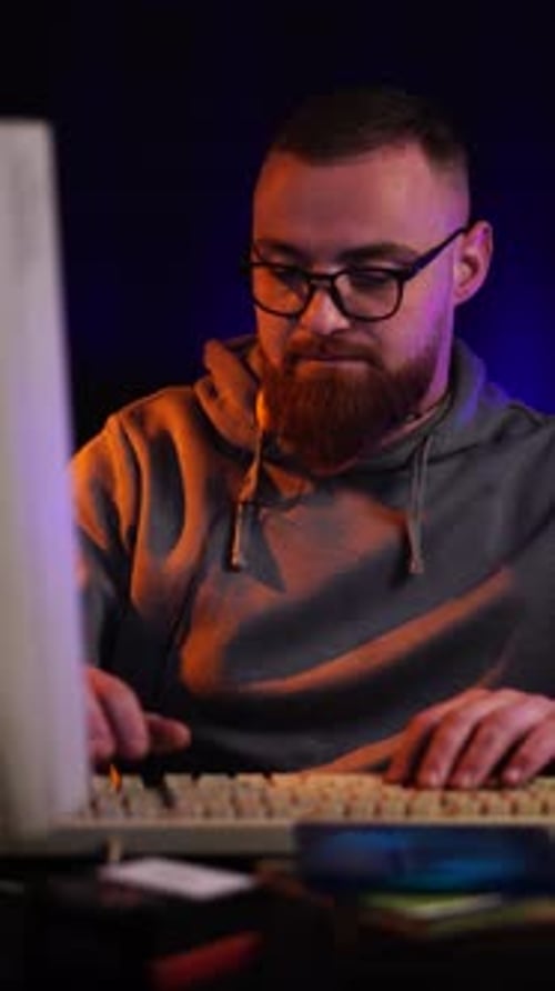 Man Typing on Computer Keyboard at Home