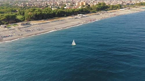 Small Sailboat Sails in the Sea
