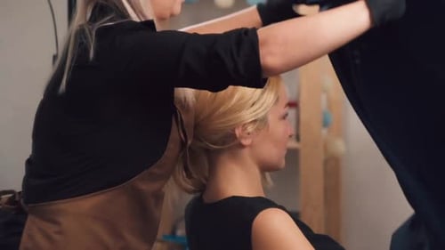 Stylist Preparing Blonde Woman in Hair Salon