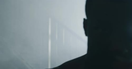 Cinematic shot of a professional young muscular shirtless african man is practicing shadow boxing