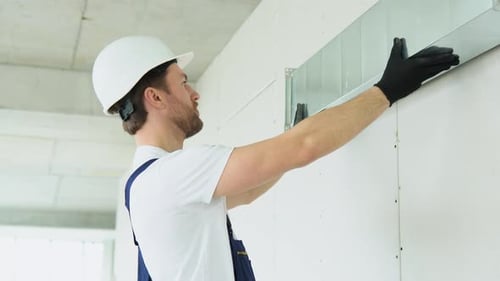 Installer Assembles Ventilation Ductwork in Construction Site