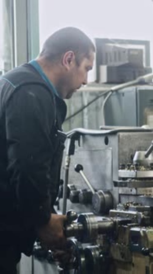 Metal lathe operation by skilled machinist in industrial workshop