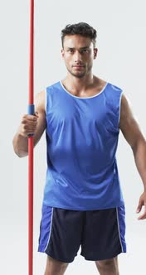 Athletic Man Holding Orange Javelin in Studio