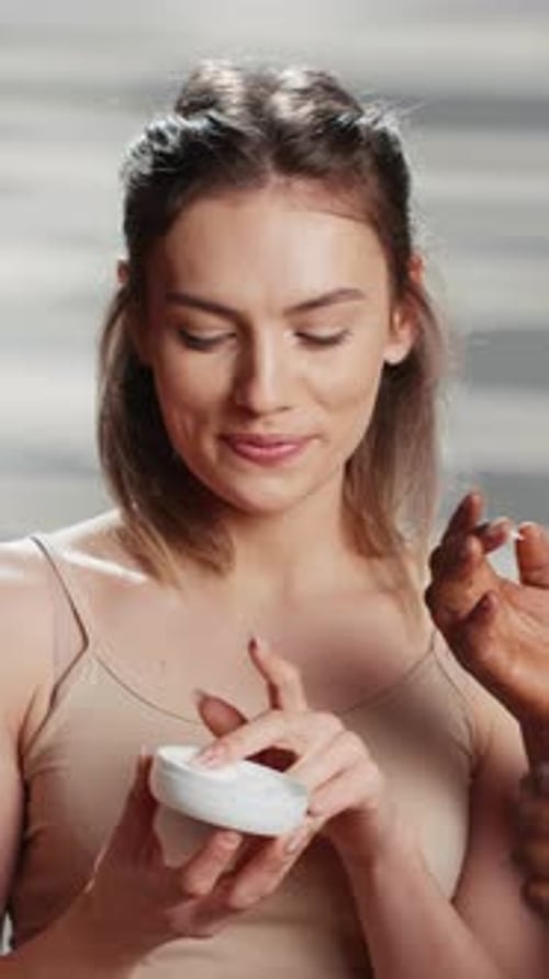 Blonde Woman Applying Moisturizer to Her Face