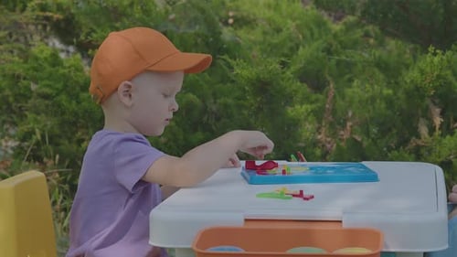 Three Year Old Boy Putting Togeather A Puzzle In Home Garden 2