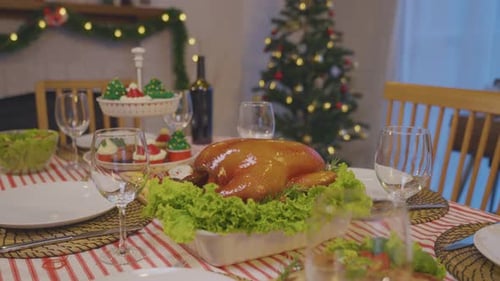 Shot of Christmas turkey and many of foods on table in decorating room.