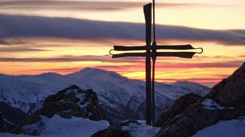 Pan Shot of a Christian Catholic Cross on Top of a Mountain in Winter at Christmas