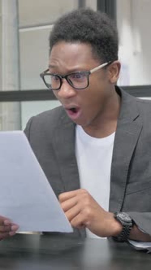 Man in Blazer Reacts Negatively to Document News