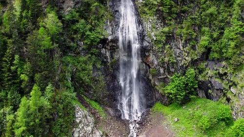 Panning shot left to right of a beautiful waterfall on a mountain side