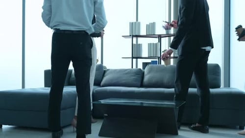 Colleagues Gather for Informal Meeting in Modern Office